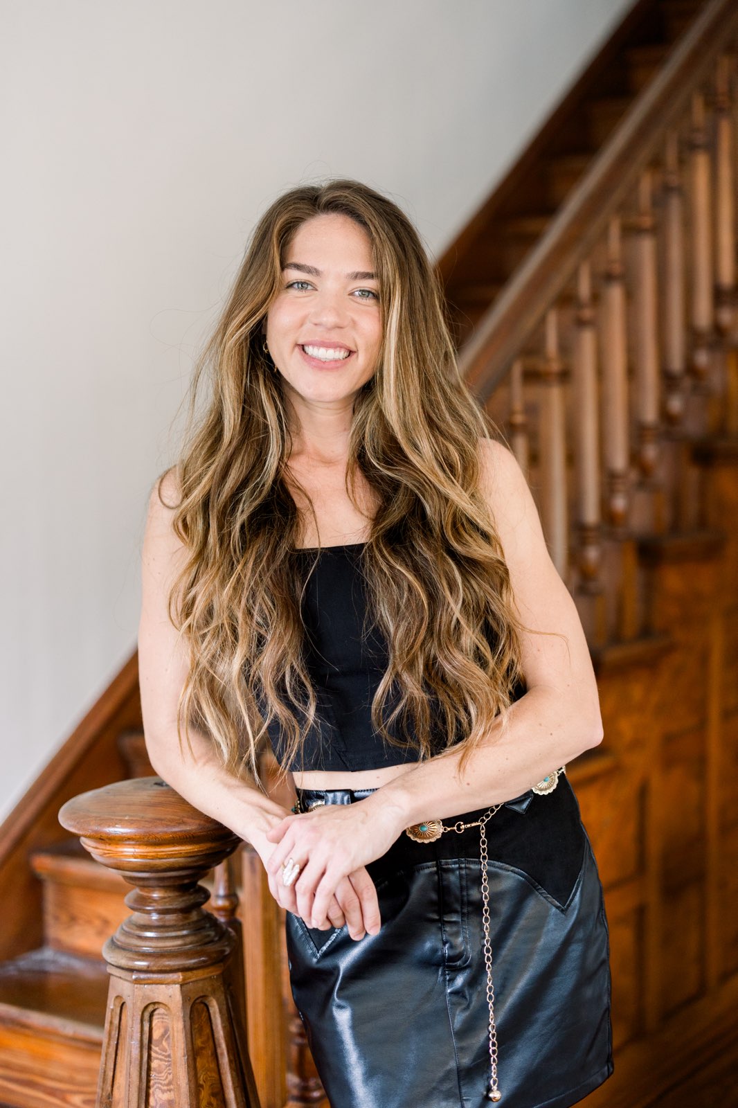 Morgan Murray smiling in front of a house